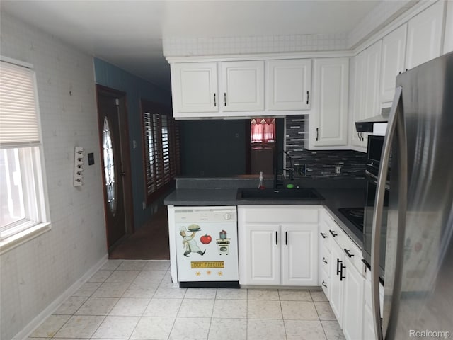 24781 Larkins St, Southfield, MI 48033 - kitchen with white dishwasher, freestanding refrigerator, a sink, dark countertops, and white cabinetry