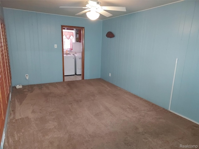 24781 Larkins St, Southfield, MI 48033 - spare room with independent washer and dryer, carpet floors, a ceiling fan, and wooden walls