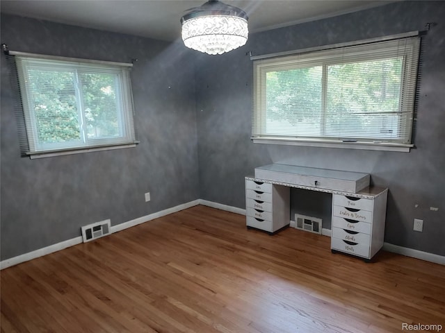 24781 Larkins St, Southfield, MI 48033 - unfurnished office featuring healthy amount of natural light, wood finished floors, a chandelier, and baseboards