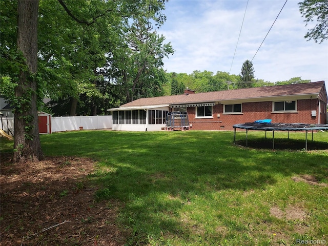 24781 Larkins St, Southfield, MI 48033 - back of house with a trampoline, a sunroom, and brick siding
