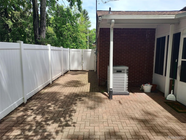 24781 Larkins St, Southfield, MI 48033 - fenced backyard featuring central air condition unit and a patio area