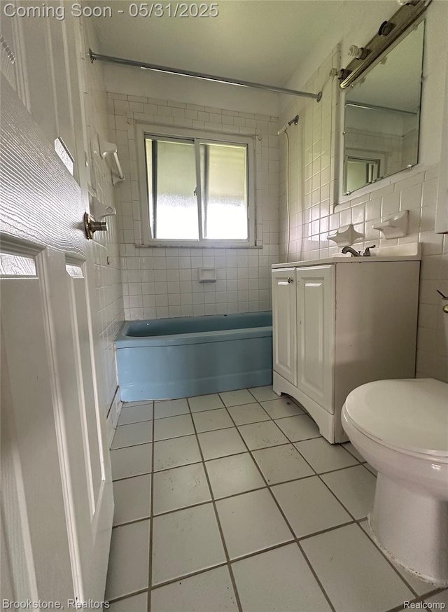 27261 Academy St, Roseville, MI 48066 - full bathroom with tile patterned floors, tile walls, shower / washtub combination, vanity, and toilet