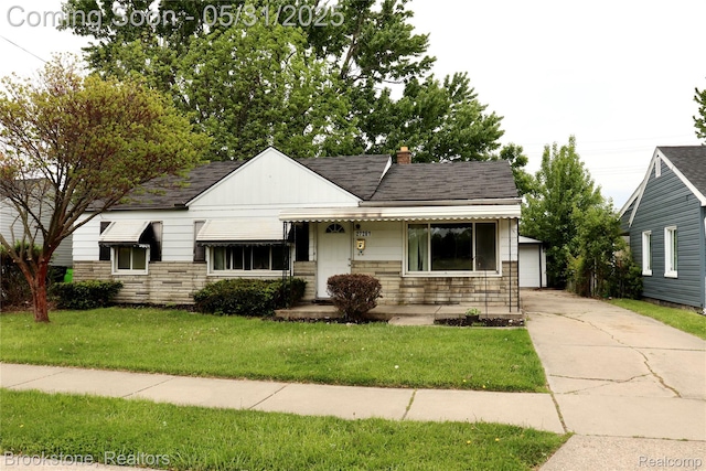 27261 Academy St, Roseville, MI 48066 - bungalow-style house featuring stone siding, a front lawn, a chimney, an outbuilding, and roof with shingles