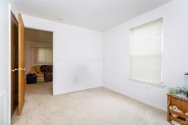 28399 Felician St, Roseville, MI 48066 - empty room with light colored carpet, a smoke detector, and baseboards