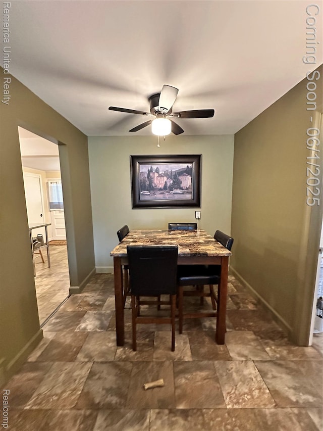 9044 N Sheldon Rd, Plymouth, MI 48170 - dining space featuring baseboards, a ceiling fan, and dark stone finish flooring