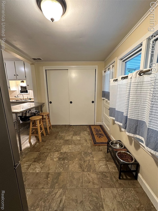 9044 N Sheldon Rd, Plymouth, MI 48170 - entrance foyer with baseboards, stone finish flooring, and a textured ceiling