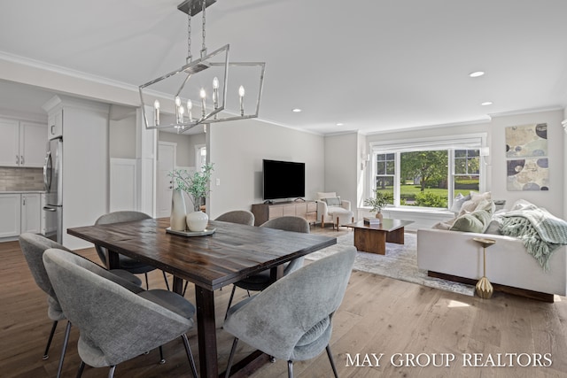 2050 Anderson Dr SE, East Grand Rapids, MI 49506 - dining area with ornamental molding, light wood-type flooring, recessed lighting, and a chandelier