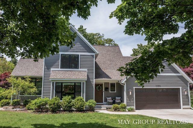 2050 Anderson Dr SE, East Grand Rapids, MI 49506 - view of front of property with a garage, roof with shingles, a front lawn, and driveway
