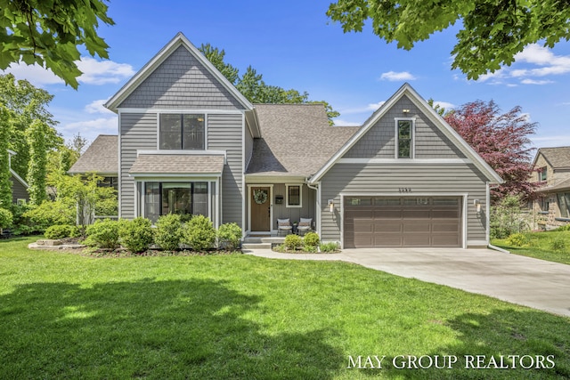 2050 Anderson Dr SE, East Grand Rapids, MI 49506 - view of front of property featuring concrete driveway, a front yard, and a shingled roof