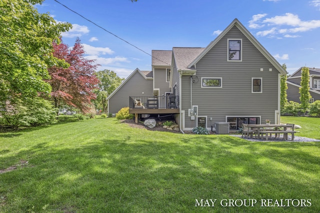 2050 Anderson Dr SE, East Grand Rapids, MI 49506 - back of house featuring central AC unit, a wooden deck, a yard, and a shingled roof