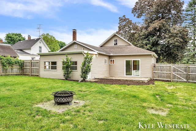 810 James St, Belding, MI 48809 - back of property with a fire pit, a chimney, and a shingled roof