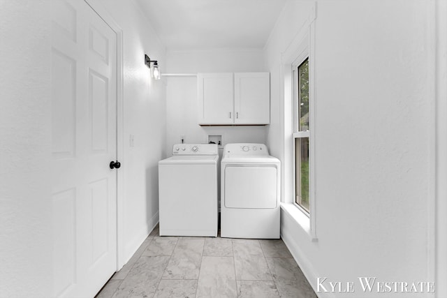 810 James St, Belding, MI 48809 - washroom featuring cabinet space, washing machine and dryer, light marble finish floors, and baseboards
