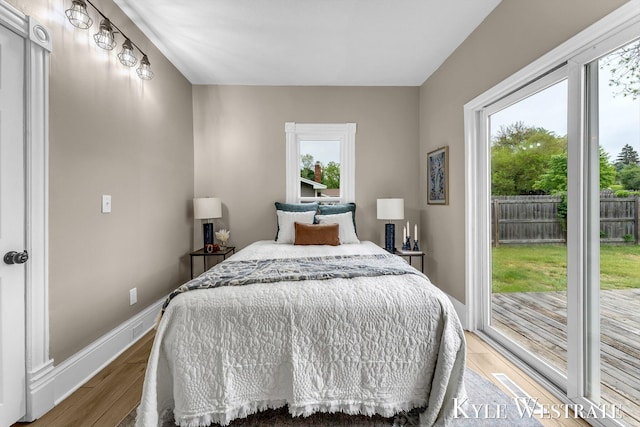 810 James St, Belding, MI 48809 - bedroom featuring light wood-type flooring, access to outside, and baseboards