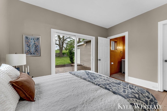 810 James St, Belding, MI 48809 - bedroom with access to outside, baseboards, and wood finished floors