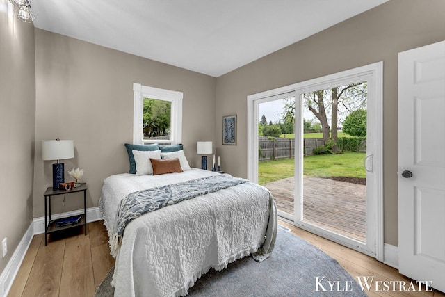 810 James St, Belding, MI 48809 - bedroom with access to exterior, light wood finished floors, and baseboards