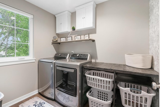 10321 E C Ave, Richland, MI 49083 - laundry room with washing machine and dryer, cabinet space, wood finished floors, and baseboards