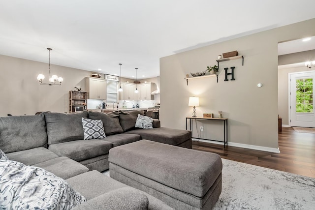 10321 E C Ave, Richland, MI 49083 - living room featuring dark wood-style floors, a chandelier, baseboards, arched walkways, and recessed lighting