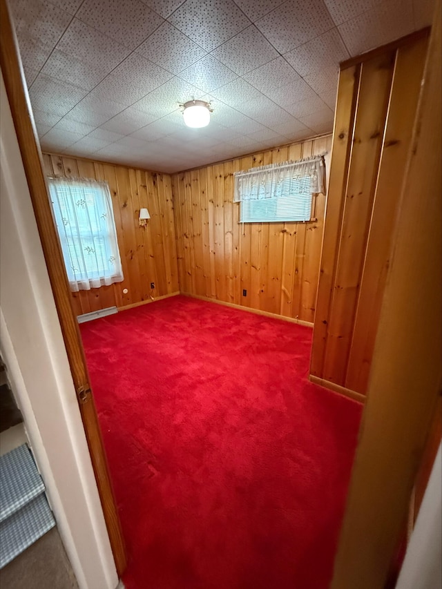 538 Wharton Ave, Ypsilanti, MI 48198 - spare room with carpet flooring and wooden walls