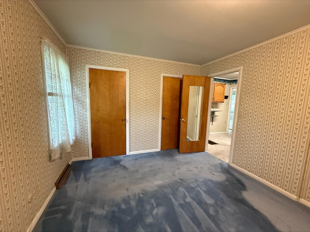 538 Wharton Ave, Ypsilanti, MI 48198 - unfurnished bedroom featuring wallpapered walls, multiple closets, carpet floors, and ornamental molding