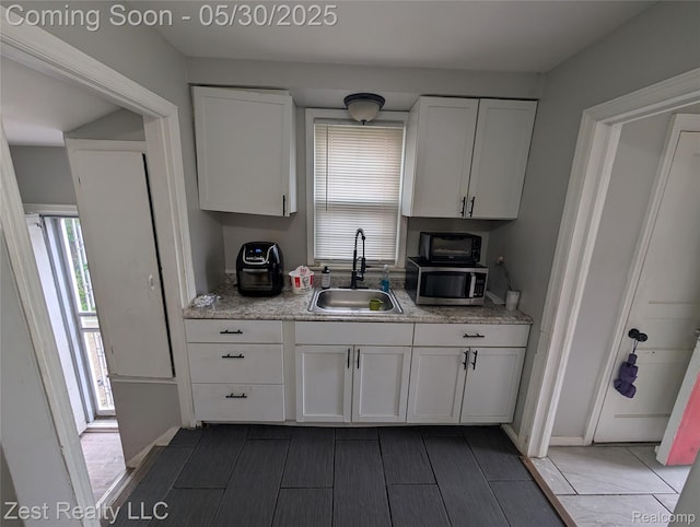 15340 Heyden St, Detroit, MI 48223 - kitchen featuring a sink, stainless steel microwave, and white cabinets