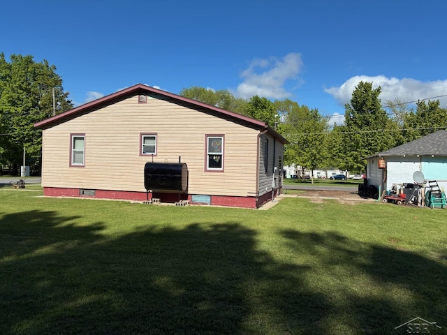 5681 W Fox Rd, Mears, MI 49436 - back of property with a lawn and heating fuel