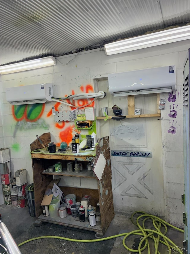 5681 W Fox Rd, Mears, MI 49436 - garage featuring concrete block wall and a wall mounted AC