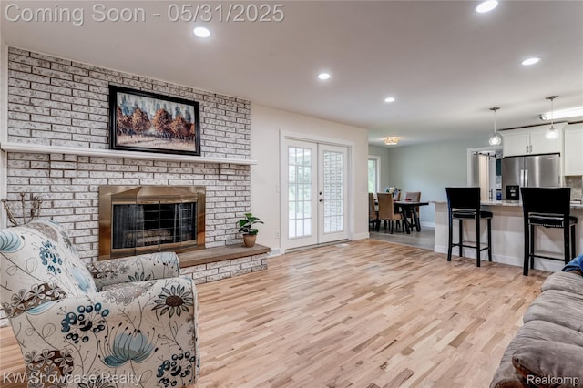 12225 Jeffers Ln, Fenton, MI 48430 - living area featuring light wood finished floors, recessed lighting, baseboards, and a fireplace