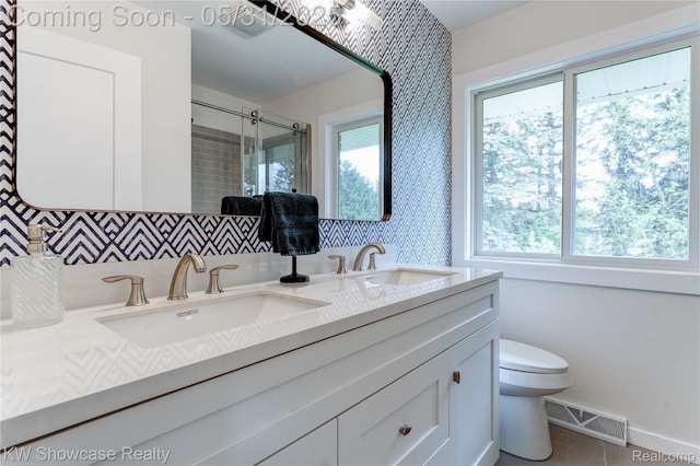 12225 Jeffers Ln, Fenton, MI 48430 - bathroom with double vanity, toilet, a stall shower, baseboards, and tile patterned floors