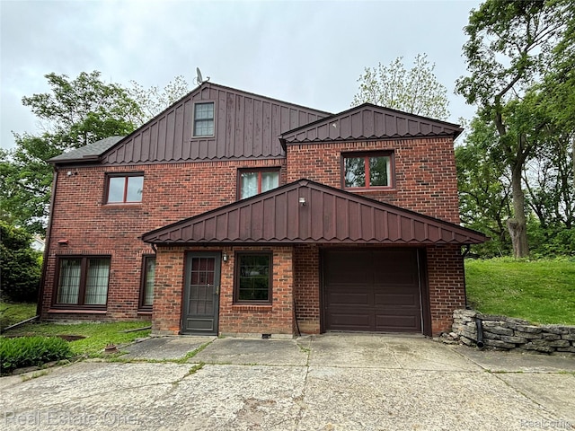 109 W Kennett Rd, Pontiac, MI 48340 - view of front of home featuring board and batten siding, brick siding, and driveway
