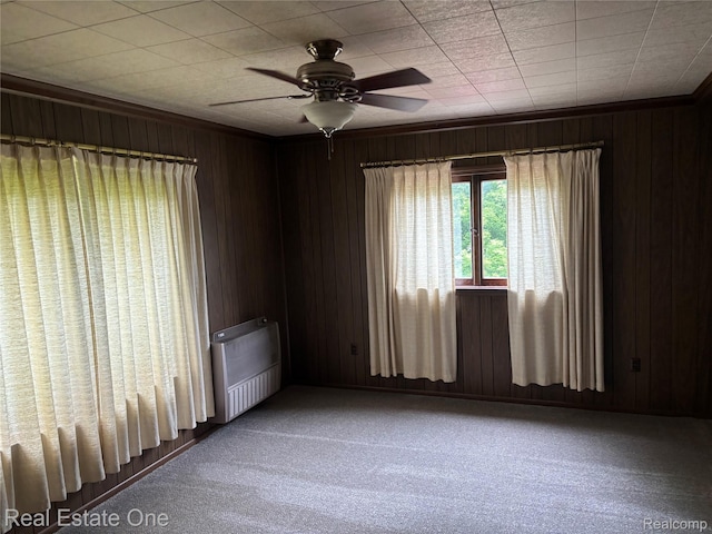 109 W Kennett Rd, Pontiac, MI 48340 - carpeted spare room featuring ceiling fan, wooden walls, and radiator