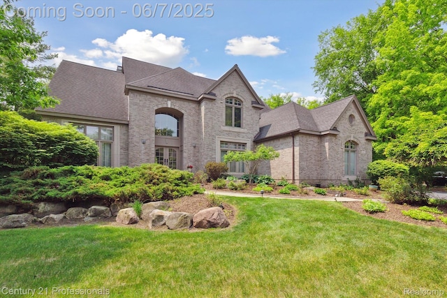 6642 Carlyle Ct, West Bloomfield, MI 48322 - french country inspired facade featuring brick siding, a front lawn, and a shingled roof