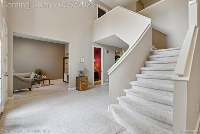 6642 Carlyle Ct, West Bloomfield, MI 48322 - tiled entrance foyer featuring stairway, baseboards, and a towering ceiling