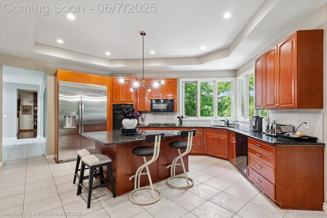 6642 Carlyle Ct, West Bloomfield, MI 48322 - kitchen featuring black appliances, a tray ceiling, tasteful backsplash, light tile patterned floors, and recessed lighting