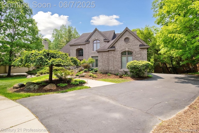 6642 Carlyle Ct, West Bloomfield, MI 48322 - french country style house with brick siding and a chimney