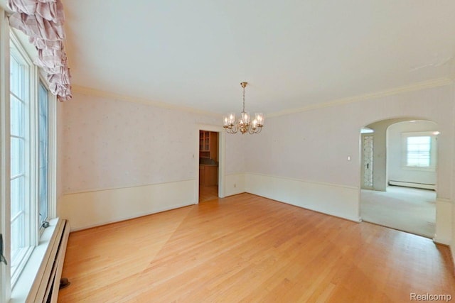 25490 E River Rd, Grosse Ile, MI 48138 - unfurnished room featuring a baseboard radiator, arched walkways, a chandelier, wood finished floors, and ornamental molding