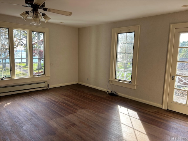 25490 E River Rd, Grosse Ile, MI 48138 - unfurnished room featuring healthy amount of natural light, dark wood finished floors, baseboard heating, and baseboards