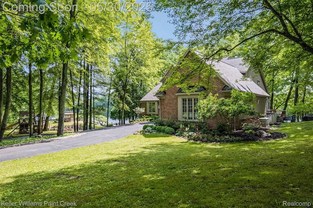 3120 Pond Rd, Leonard, MI 48367 - view of property exterior with a lawn and brick siding