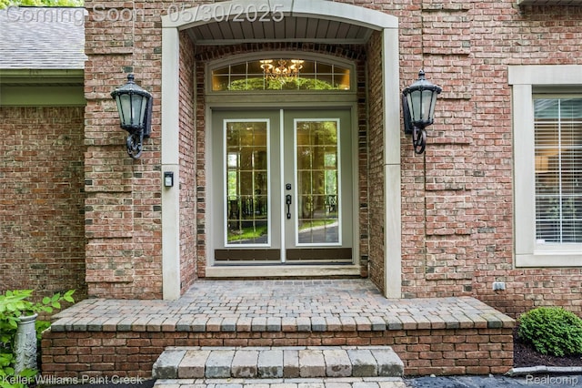 3120 Pond Rd, Leonard, MI 48367 - property entrance featuring french doors and brick siding