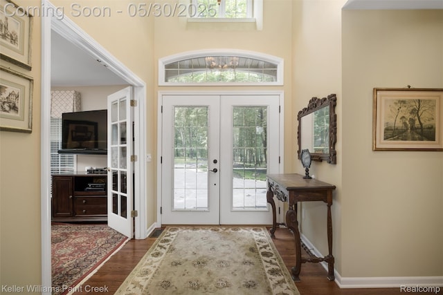 3120 Pond Rd, Leonard, MI 48367 - foyer with french doors, dark wood-style flooring, baseboards, and a towering ceiling