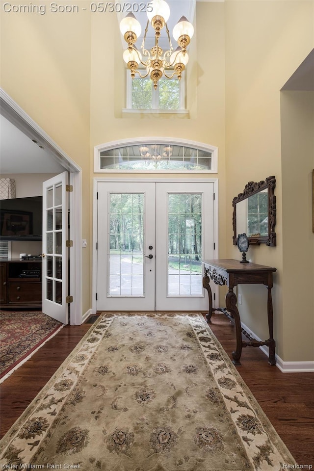3120 Pond Rd, Leonard, MI 48367 - entrance foyer featuring french doors, a chandelier, wood finished floors, baseboards, and a towering ceiling