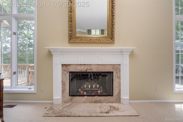 3120 Pond Rd, Leonard, MI 48367 - detailed view of a premium fireplace, carpet flooring, and baseboards