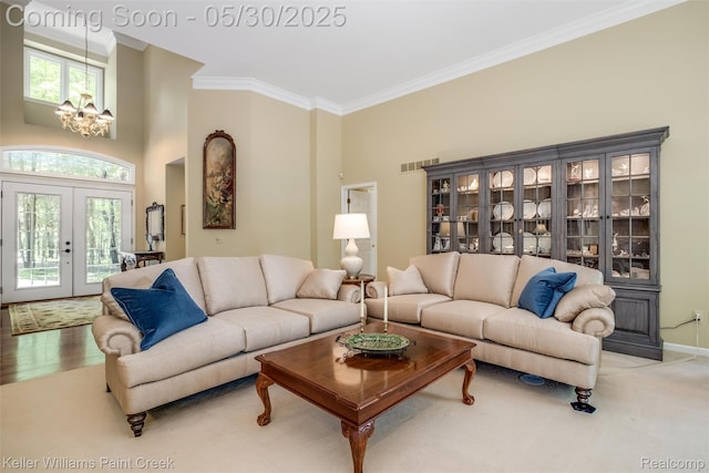 3120 Pond Rd, Leonard, MI 48367 - living room with a chandelier, ornamental molding, french doors, a high ceiling, and baseboards