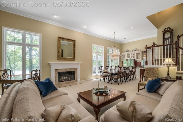 3120 Pond Rd, Leonard, MI 48367 - carpeted living area with a chandelier, a premium fireplace, ornamental molding, recessed lighting, and stairway