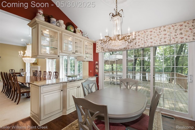 3120 Pond Rd, Leonard, MI 48367 - dining space featuring a chandelier and dark wood-type flooring