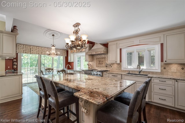 3120 Pond Rd, Leonard, MI 48367 - kitchen with a sink, cream cabinetry, a chandelier, and premium range hood