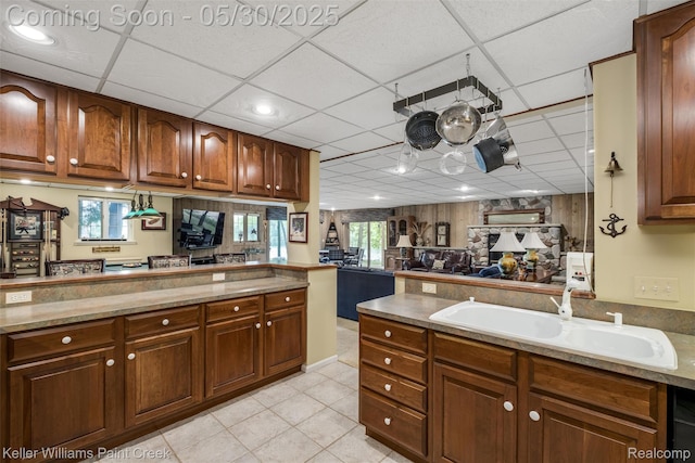 3120 Pond Rd, Leonard, MI 48367 - kitchen featuring a sink, a drop ceiling, light tile patterned floors, a peninsula, and open floor plan