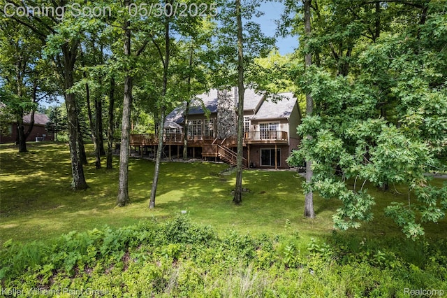 3120 Pond Rd, Leonard, MI 48367 - view of green lawn with a wooden deck and stairway