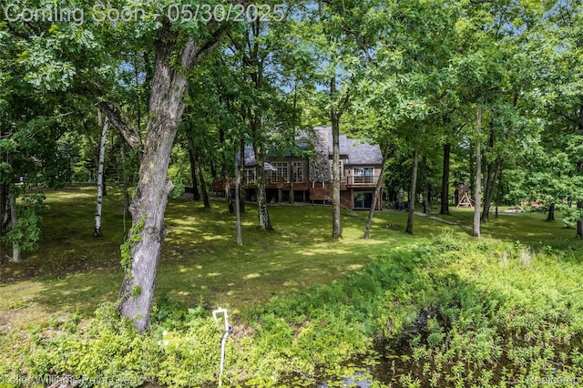 3120 Pond Rd, Leonard, MI 48367 - view of green lawn with a wooden deck