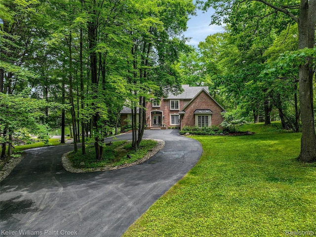 3120 Pond Rd, Leonard, MI 48367 - view of front facade featuring curved driveway and a front lawn