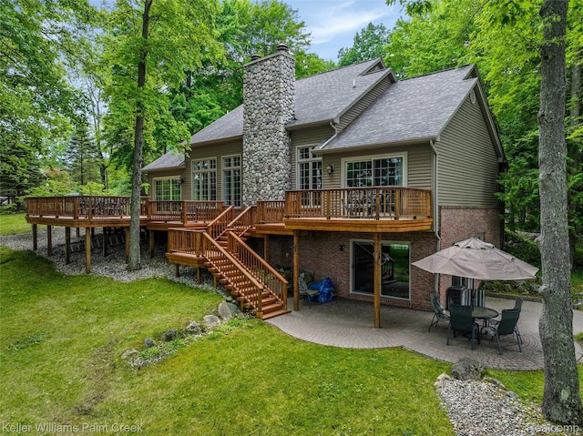 3120 Pond Rd, Leonard, MI 48367 - rear view of house featuring a patio, a wooden deck, a lawn, and a chimney